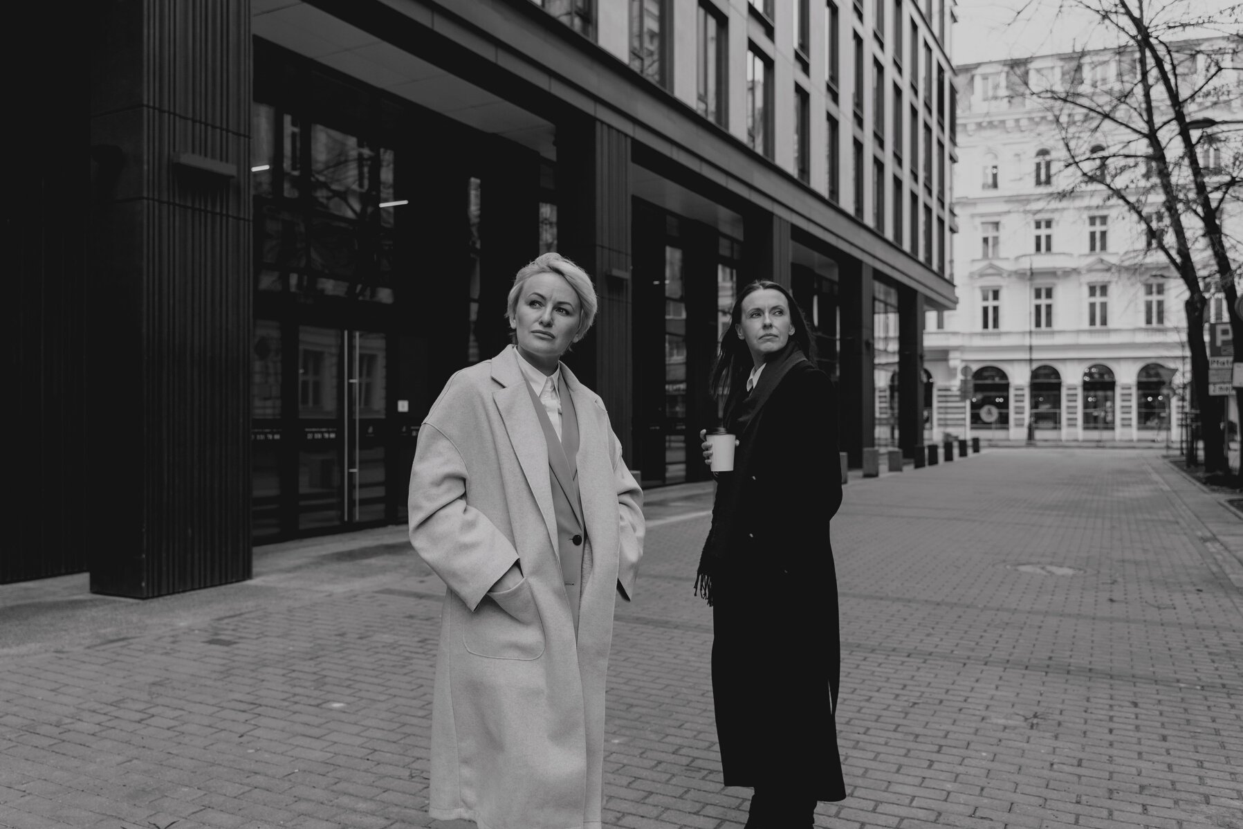 Man and Woman Standing on Sidewalk